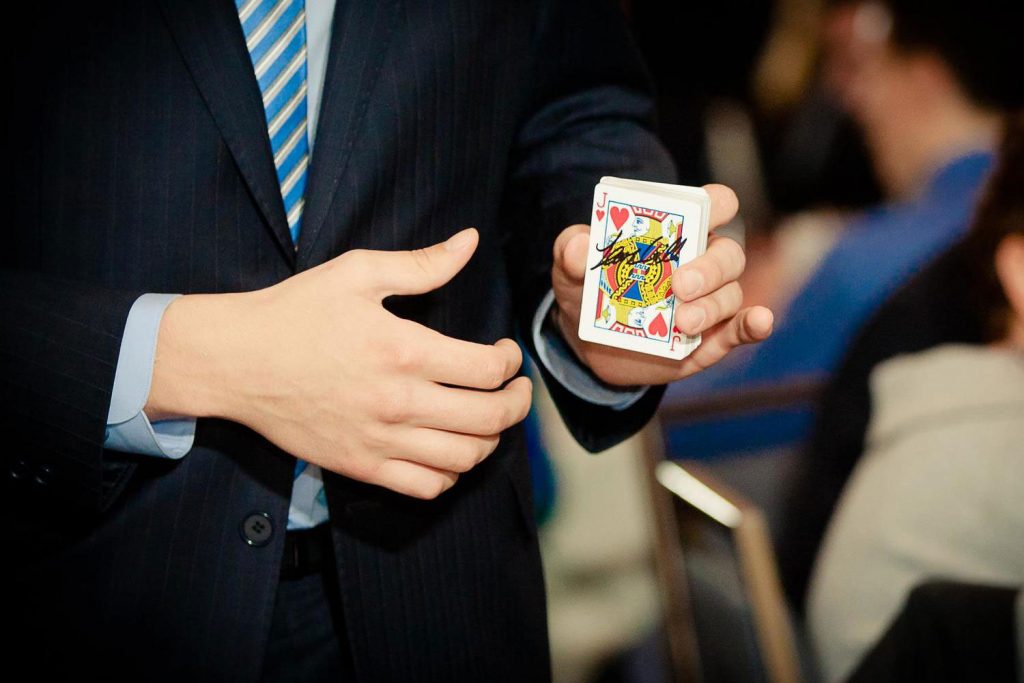 Magician Steven Brundage holding the Jack of Hearts card